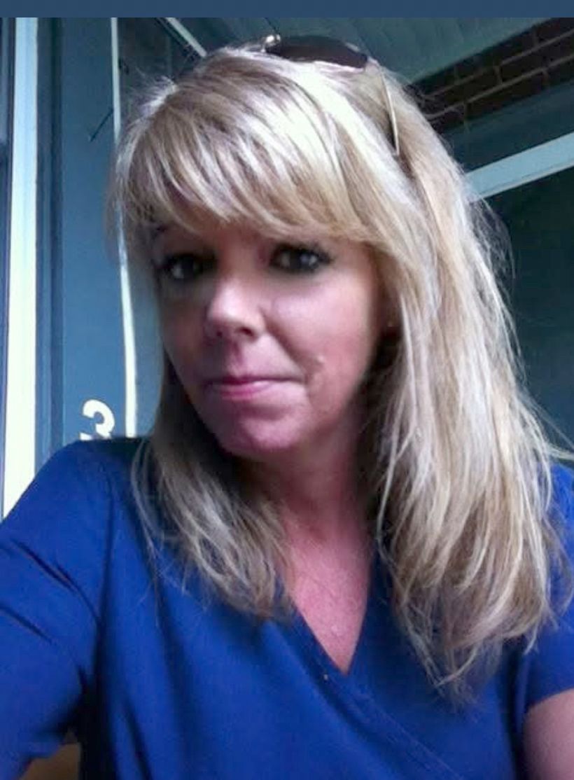 Aimee Hoppins, a White woman with blonde hair, wears a blue shirt. 
