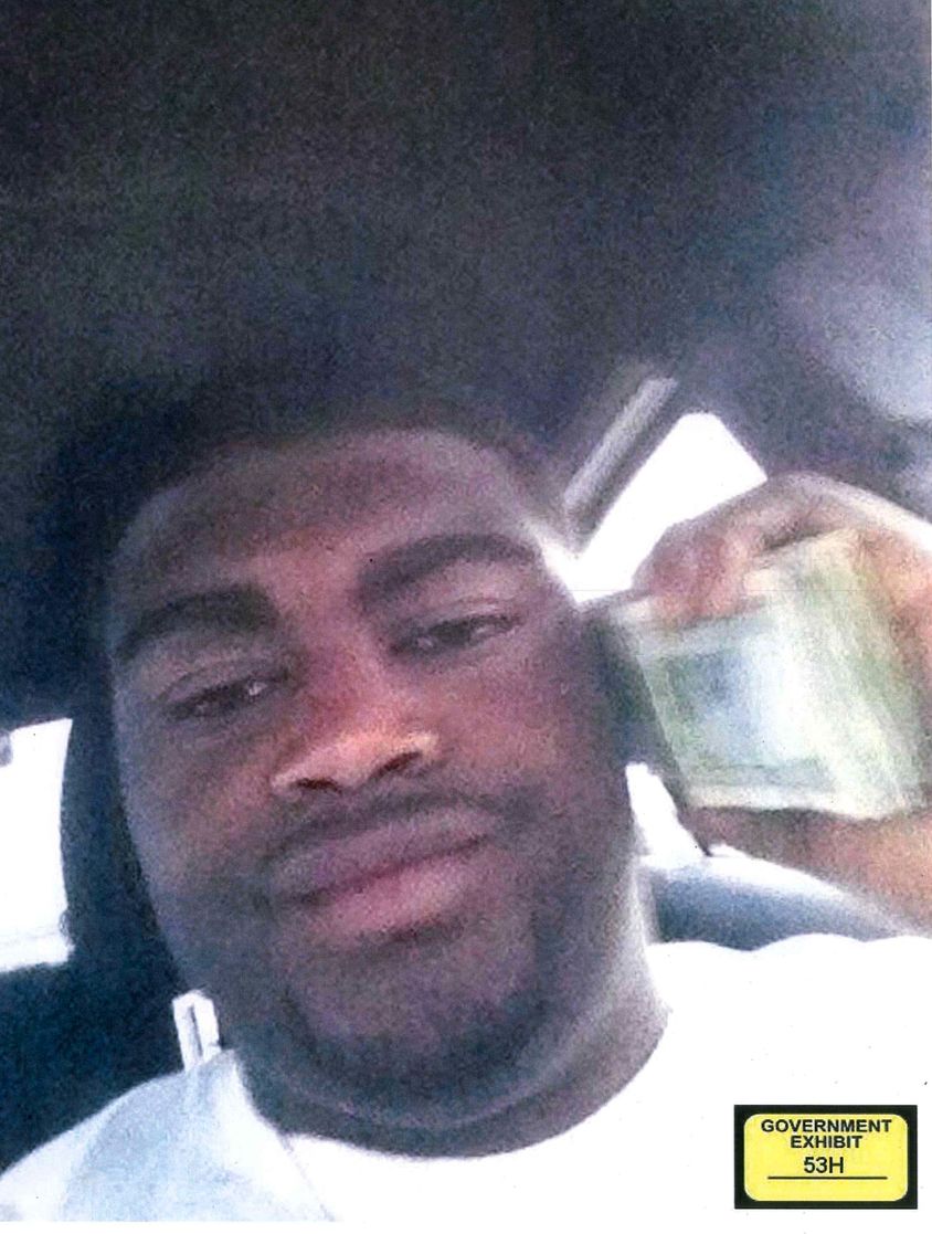 one of him holding cash, 