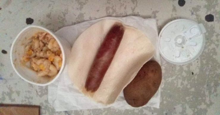  A hotdog with a tortilla, a cup of mush and a raw potato.