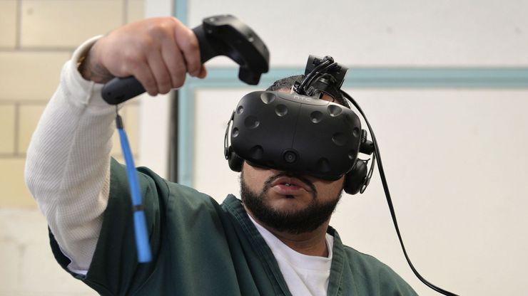 Leroy Gardenhire uses a virtual reality headset at the Fremont Correctional Facility in Cañon City, Colo., to simulate doing laundry at a laundromat.