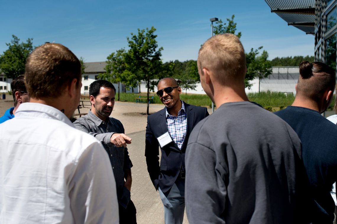 Scott Budnick, left, President of the Anti-Recidivism Coalition, and Khalil Gibran Muhammad, right, Director at Schomburg Center for Research in Black Culture in Harlem, Center talking to inmates at Neustrelitz Prison on Wednesday. 