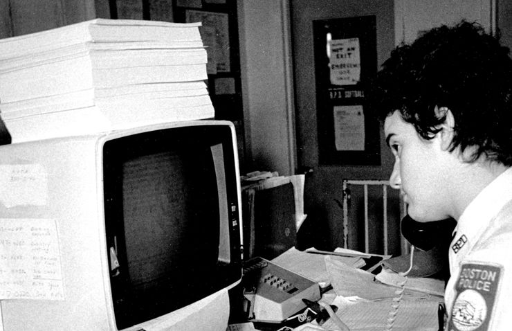 A police cadet works on a computer in the 1980s. Despite rapid advances in technology, few departments are capable or even willing to collect and share important data. 