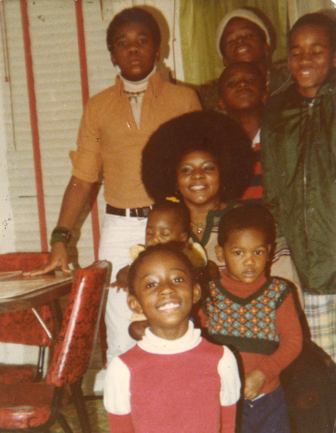 Taylor at 14, standing in the white turtleneck, with family members at Thanksgiving in 1977.