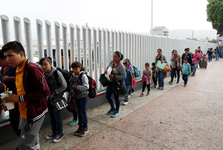 People line up in Tijuana, Mexico, to begin the process of applying for asylum in the United States.