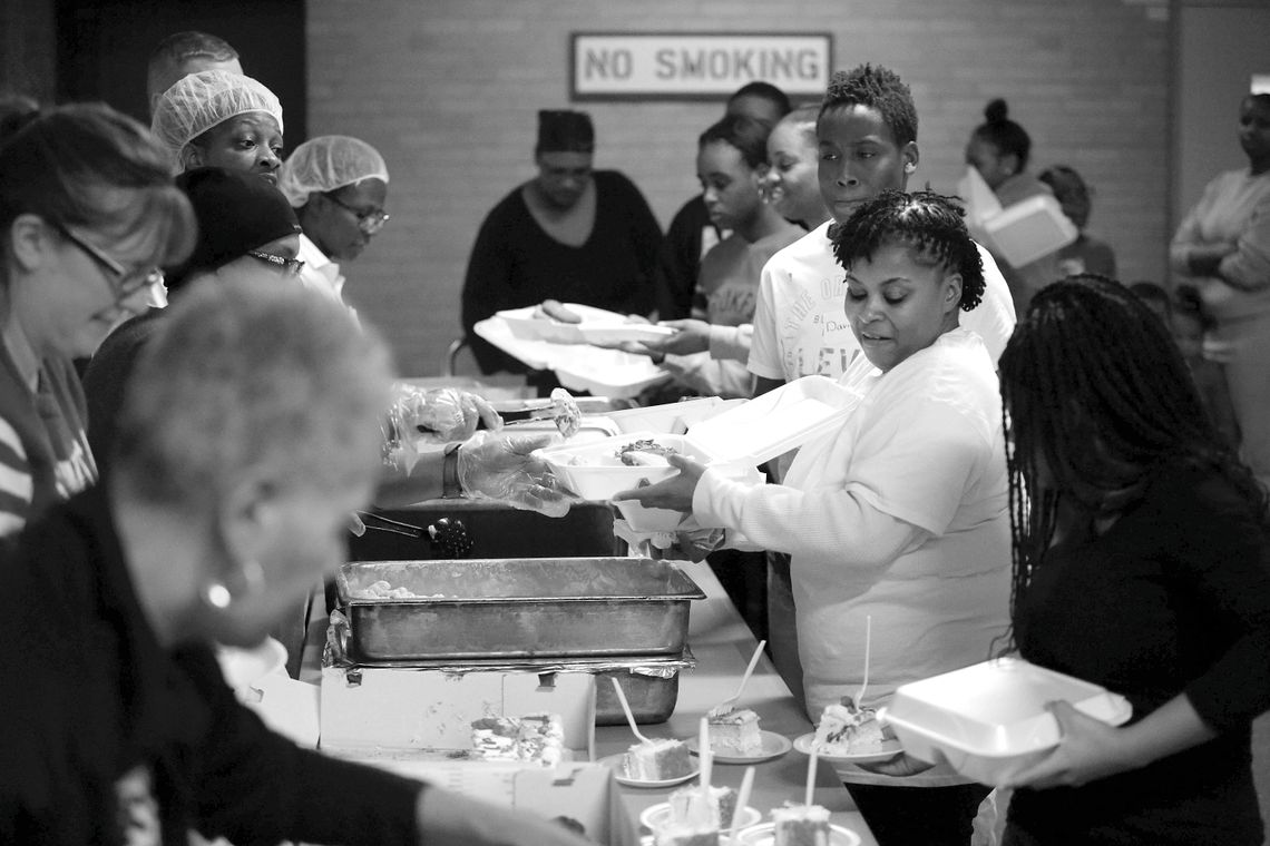 Karena Edwards, center, and her daughter being served lunch.