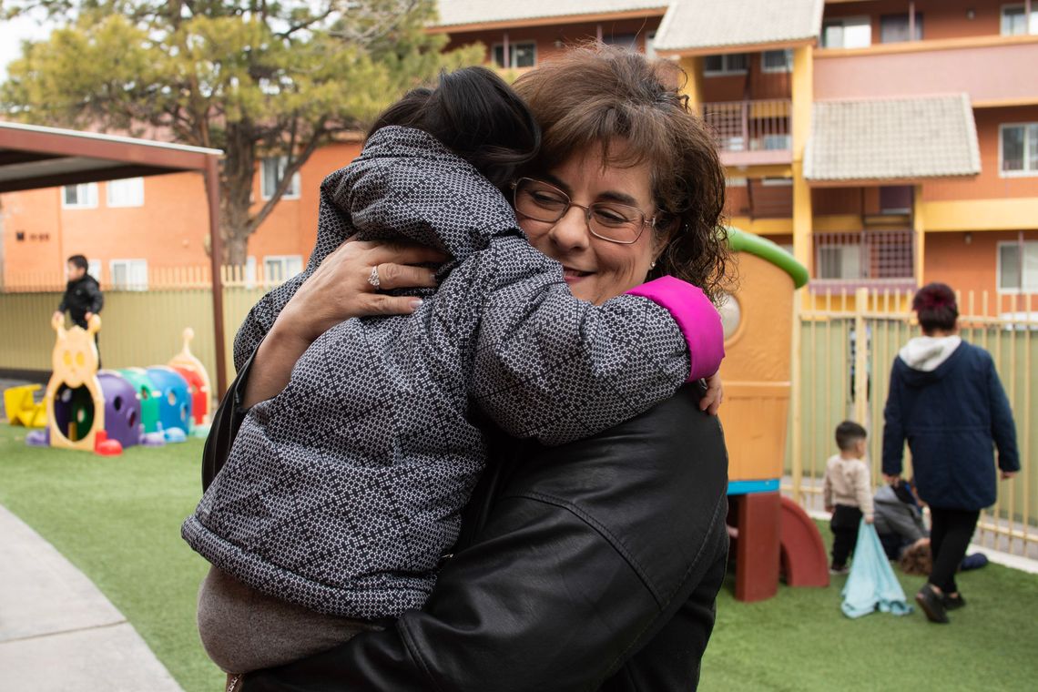 Joanna Rubi, an Albuquerque foster parent, hugs her foster child. She estimates that about a third of the nearly 200 children she has taken in have been short stays. 