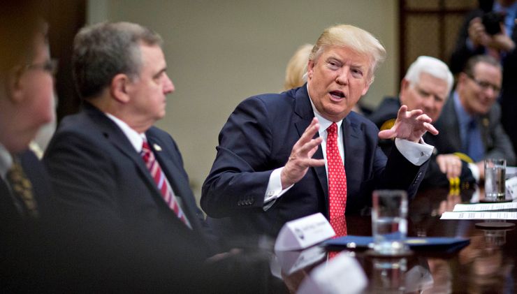 President Donald Trump meets with county sheriffs during a listening session in the White House.