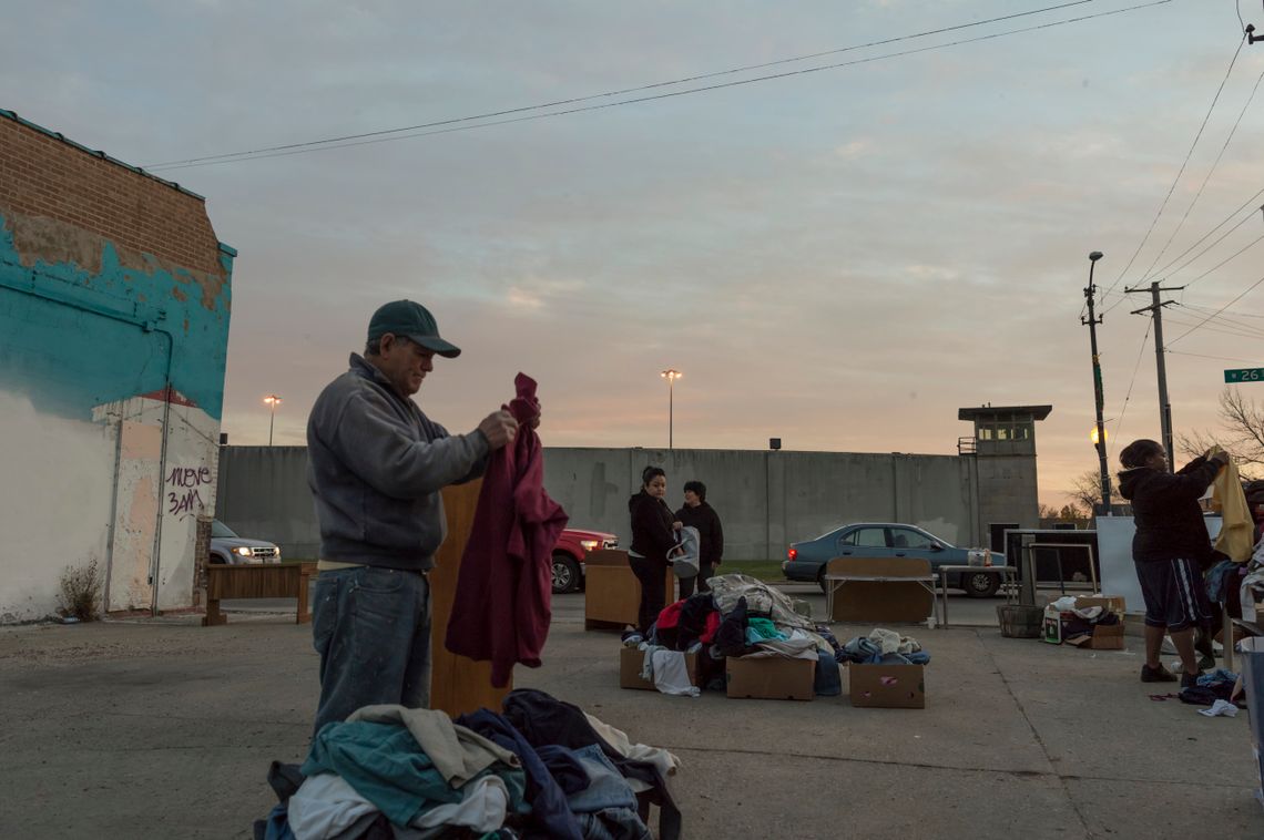 Residents of Little Village pick through clothes donated by a church.