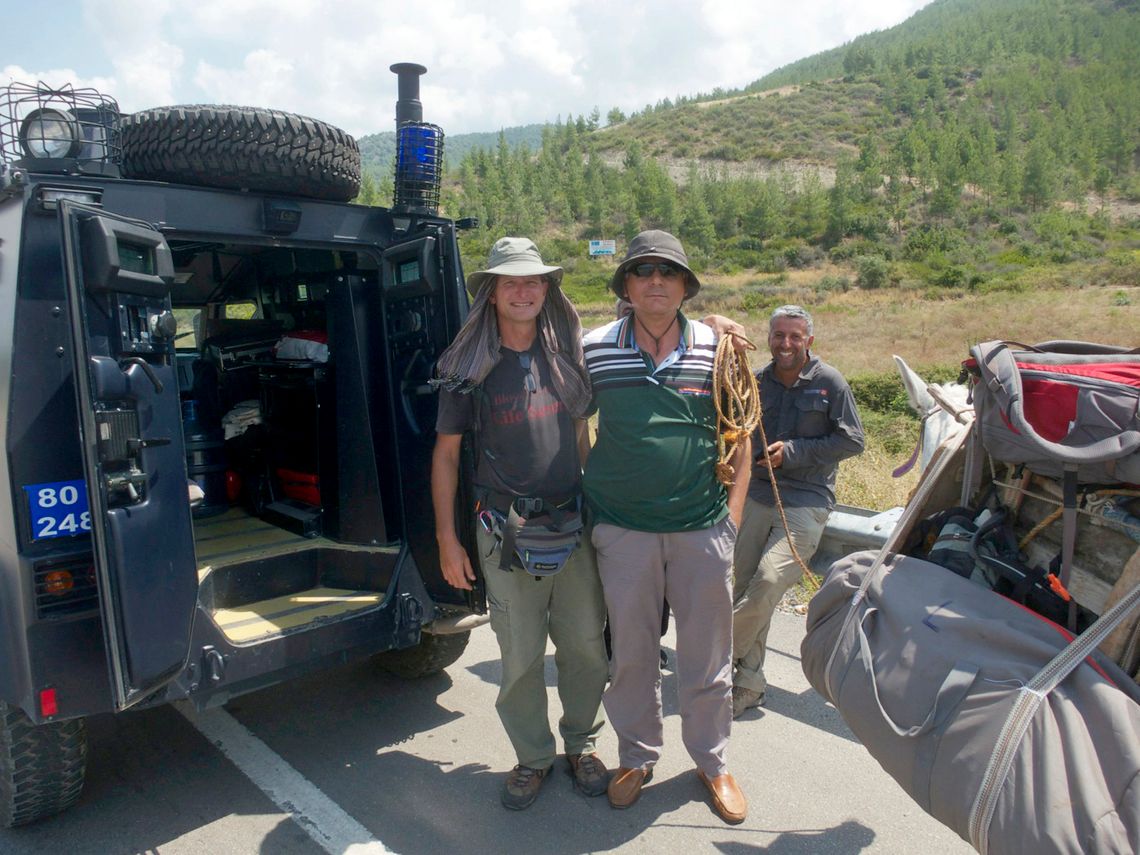 Paul Salopek, left, with an anti-terrorist police officer after being stopped with his guide, Deniz Kilic, right, on the outskirts of Osmaniye, Turkey.