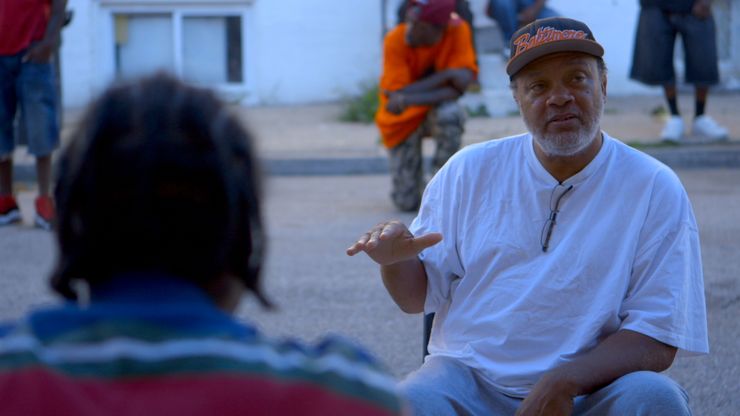 Clayton “Mr. C” Guyton holding a meeting in East Baltimore’s Rose Street community in a scene from Marilyn Ness’s documentary, “Charm City.” 