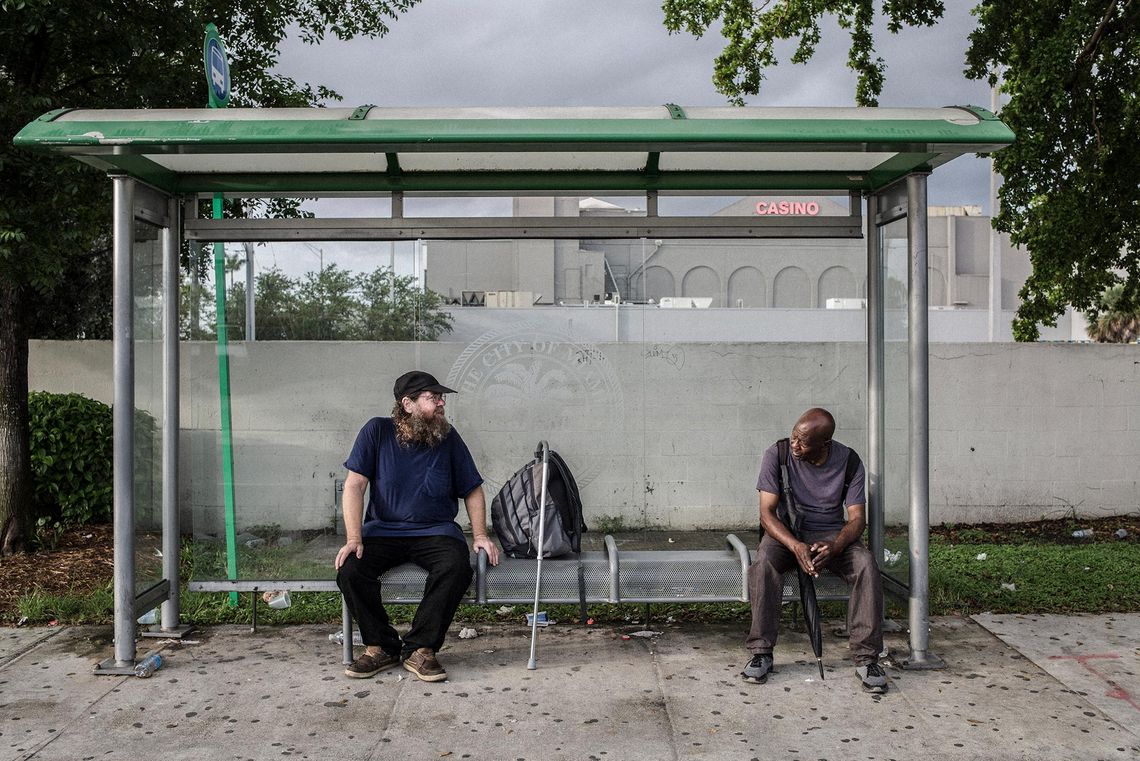 Brown and Vincent wait for the bus in the morning after curfew ends.