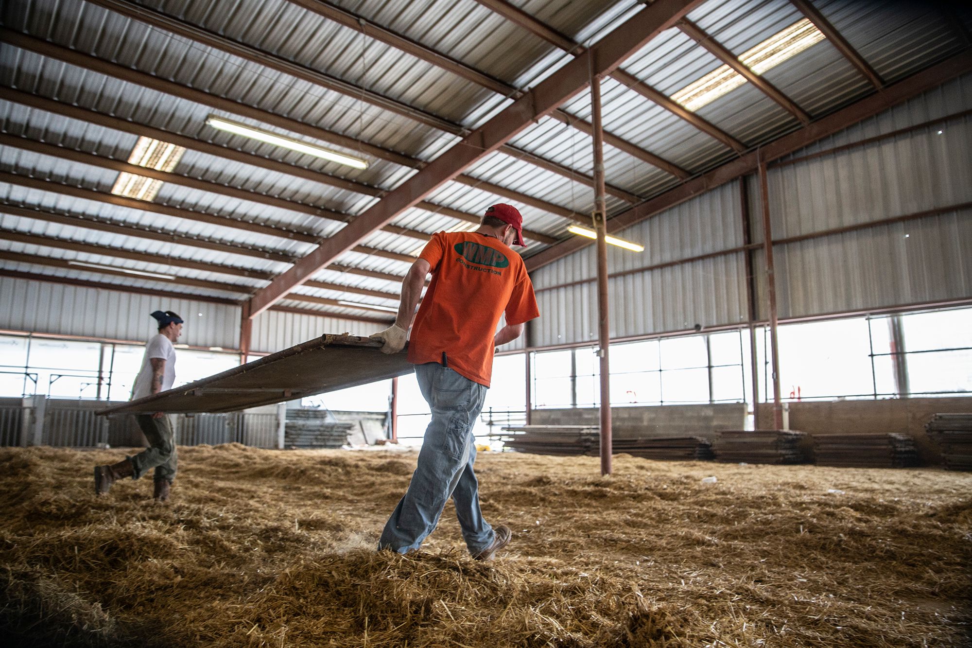 Tyler Jackson and Jerod Johnson take down fencing at the Leflore County Agri Center in Greenwood, Miss., in February of last year. Both men entered the Greenwood Restitution Center to pay off court-ordered debts in 2018.