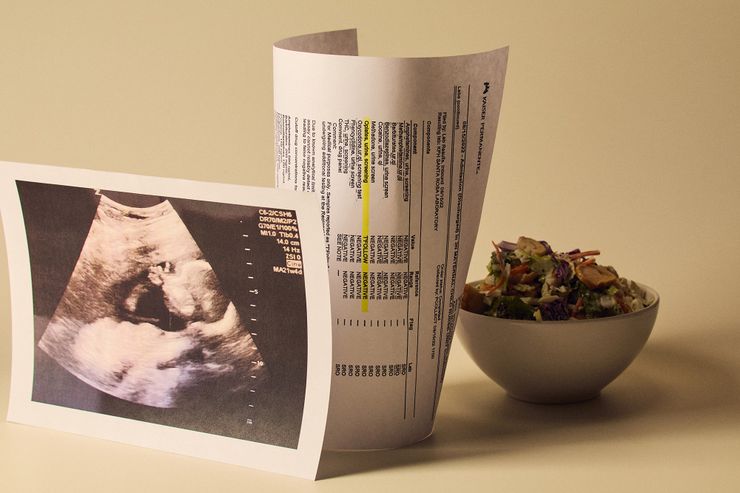Three items are arranged on a white surface: a salad in a white bowl, a copy of a sonogram, and a printout of a false positive drug test result.
