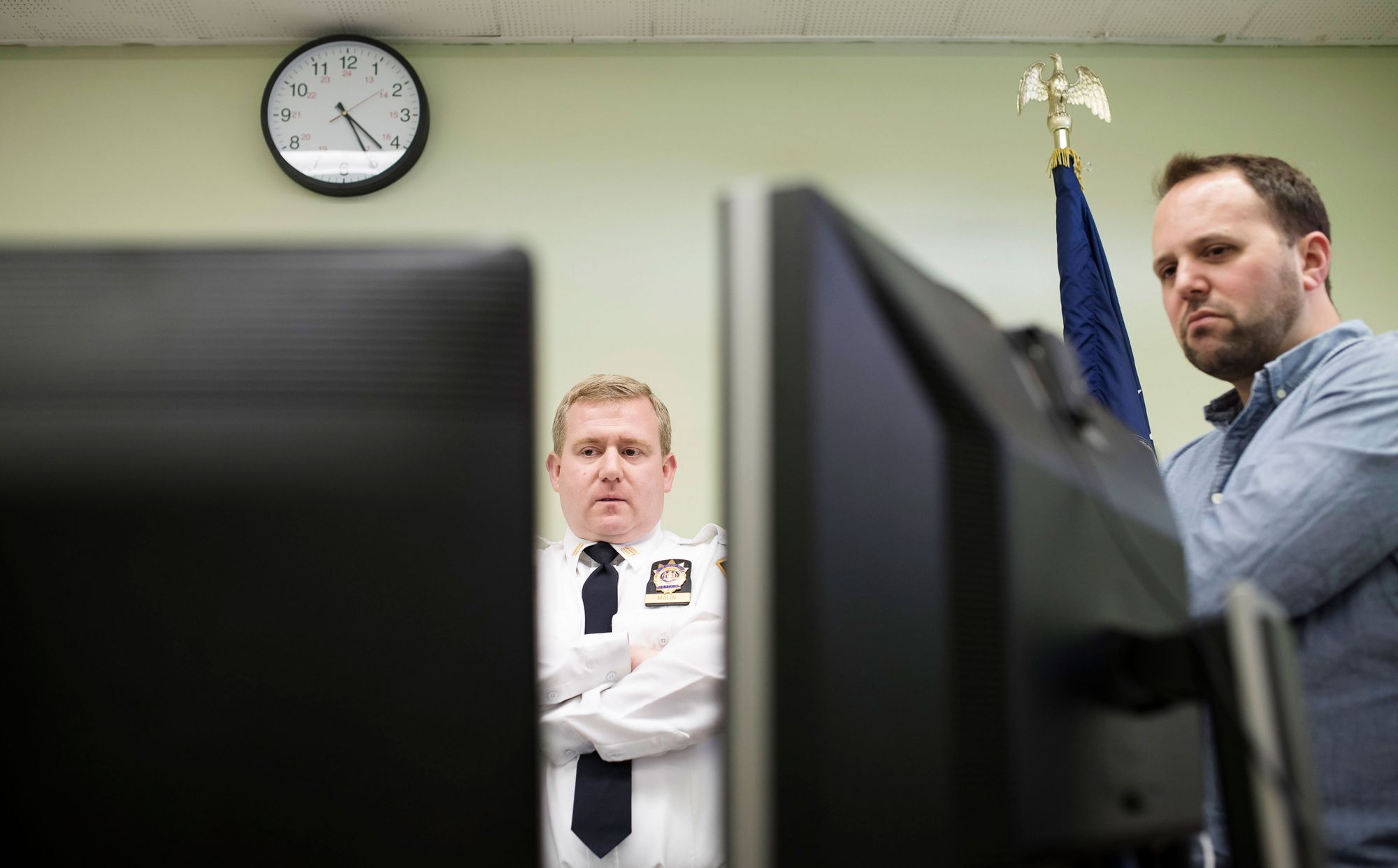 Capt. Timothy J. Malin, commanding officer of the New York Police Department’s 20th Precinct, center, meets with Michael Simon, co-founder of the startup Elucd. The company’s data tool is designed to measure public opinion about local police. 