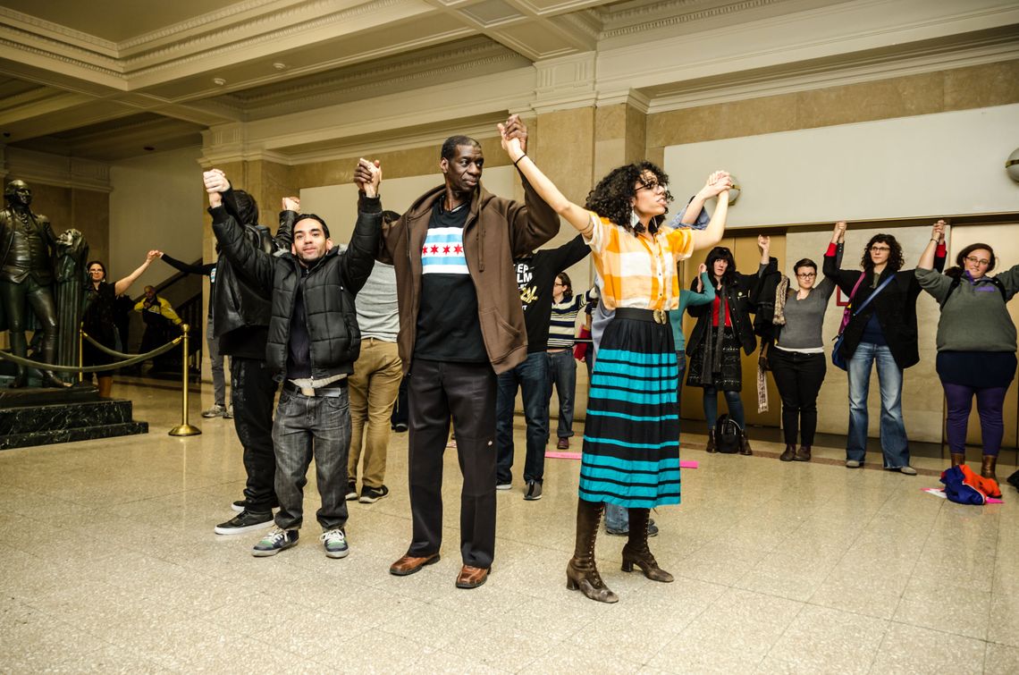 Darrell Cannon, center, with Page May, right, and Jaime Cornejo, left, at a pop-up justice art exhibit focused on police torture reparations at Chicago's City Hall in 2015. 
