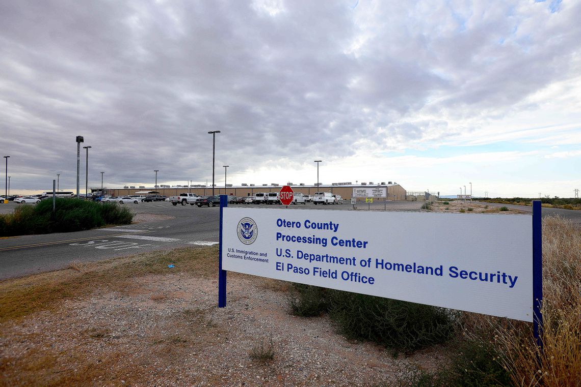 A photo shows a white sign that reads “U.S. Immigration and Customs Enforcement Otero County Processing Center” and "U.S. Department of Homeland Security El Paso Field Office." 