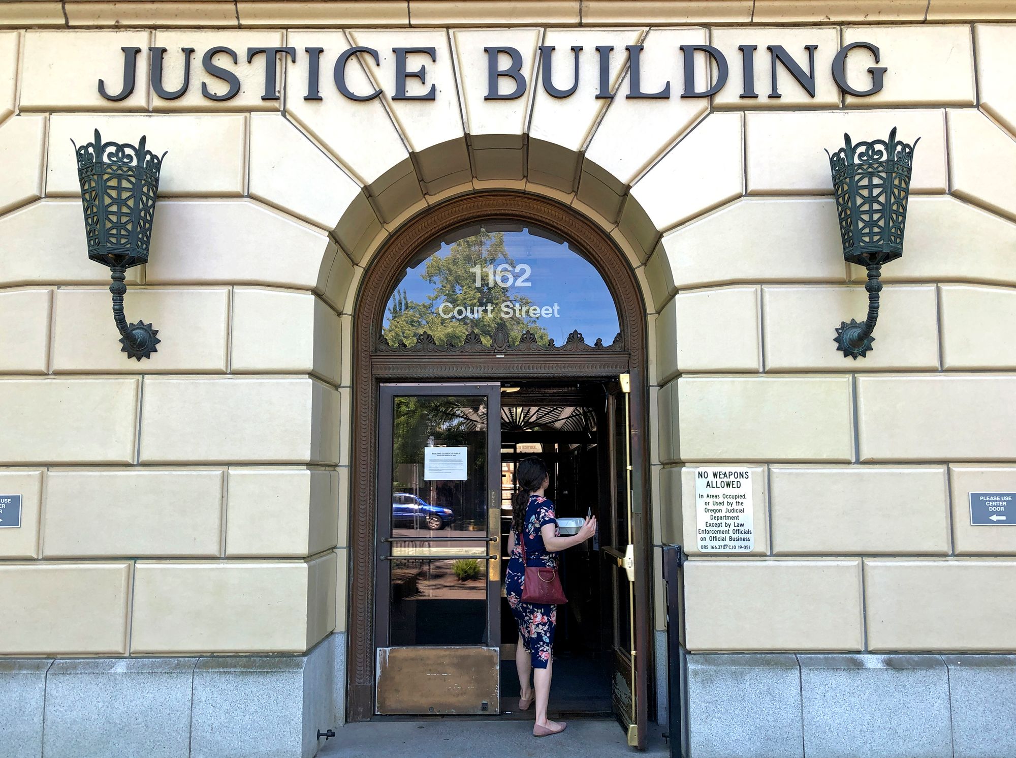 A woman enters the Oregon Department of Justice building in Salem, Ore., in 2020.
