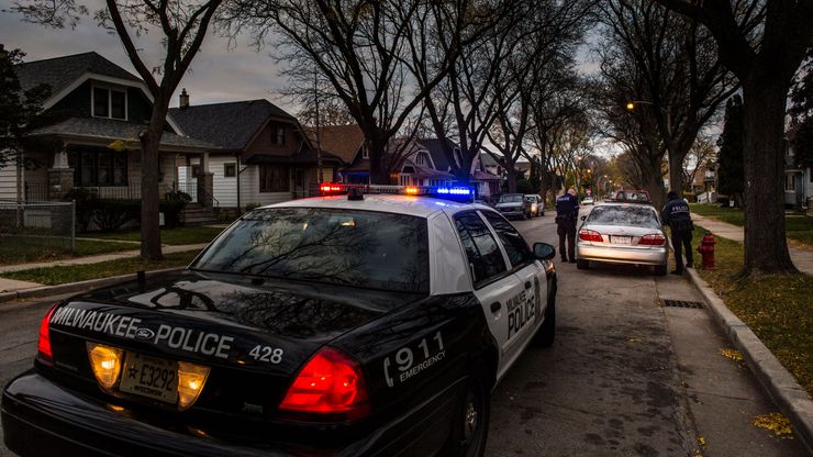 Police officers walk up to a vehicle in Milwaukee in 2014. 