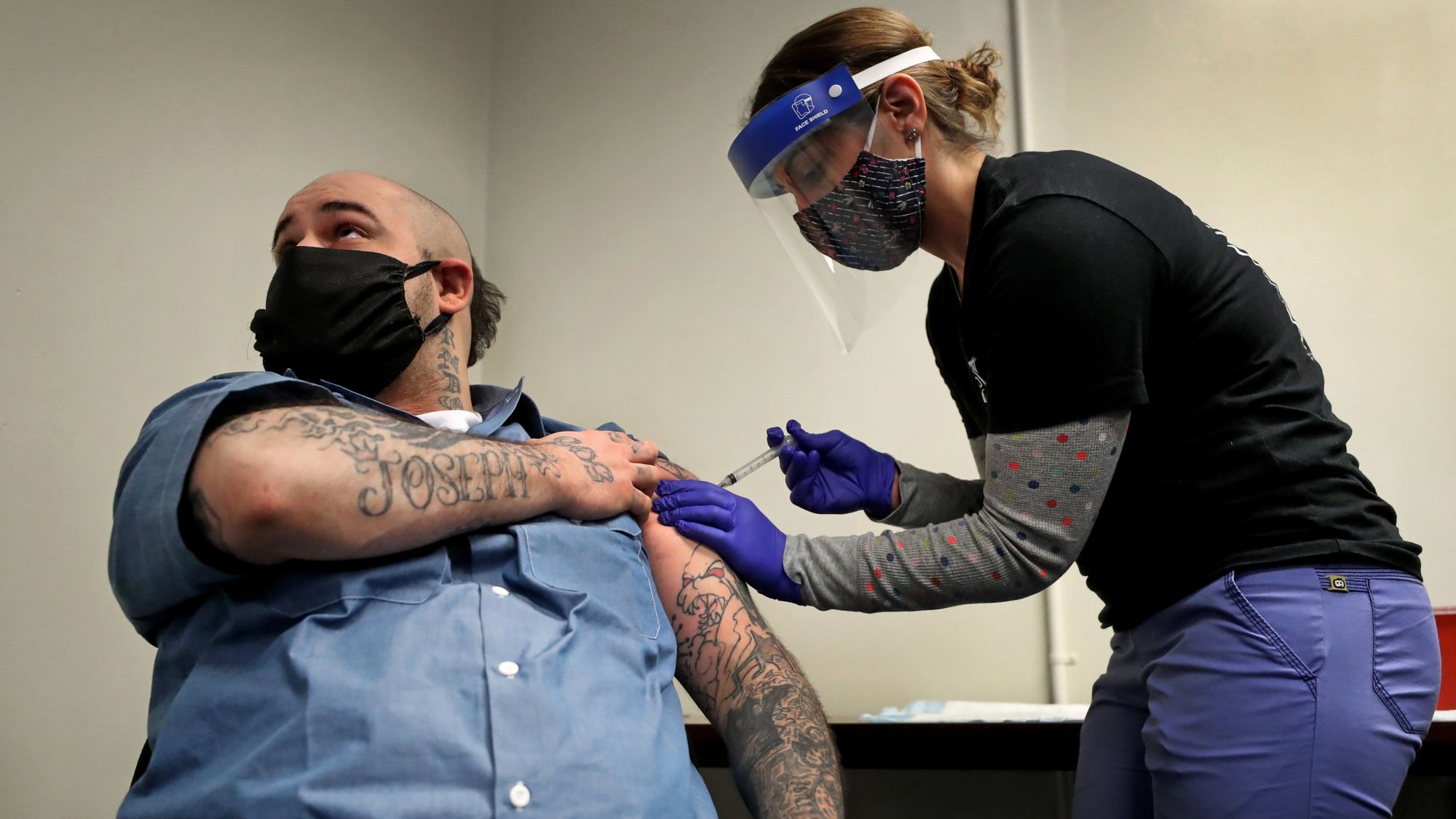 Christian Millett gets the first of two COVID-19 vaccine shots from Alyssa Dobbs, a contractor in the medical department at the Worcester County House of Corrections in West Boylston, Mass., in January. 