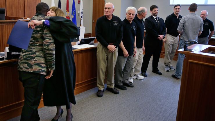 Associate Judge Pamela Woodcock Pfeiffer embraces a U.S. Army veteran after he completed a program at the Veterans Treatment Court at the Kent County Courthouse in Warwick, R.I., in 2016. 