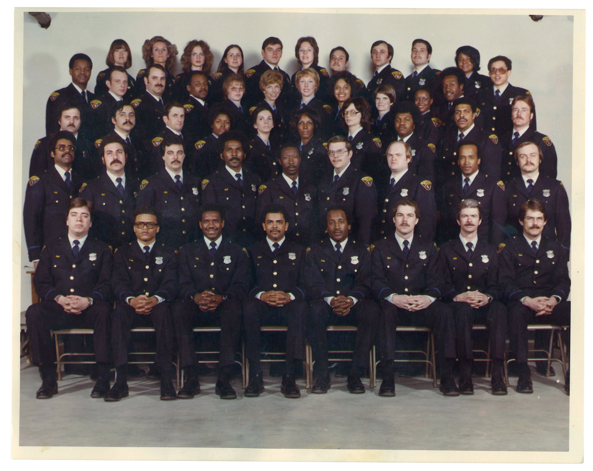 A police academy photo with dozens of people in uniform.