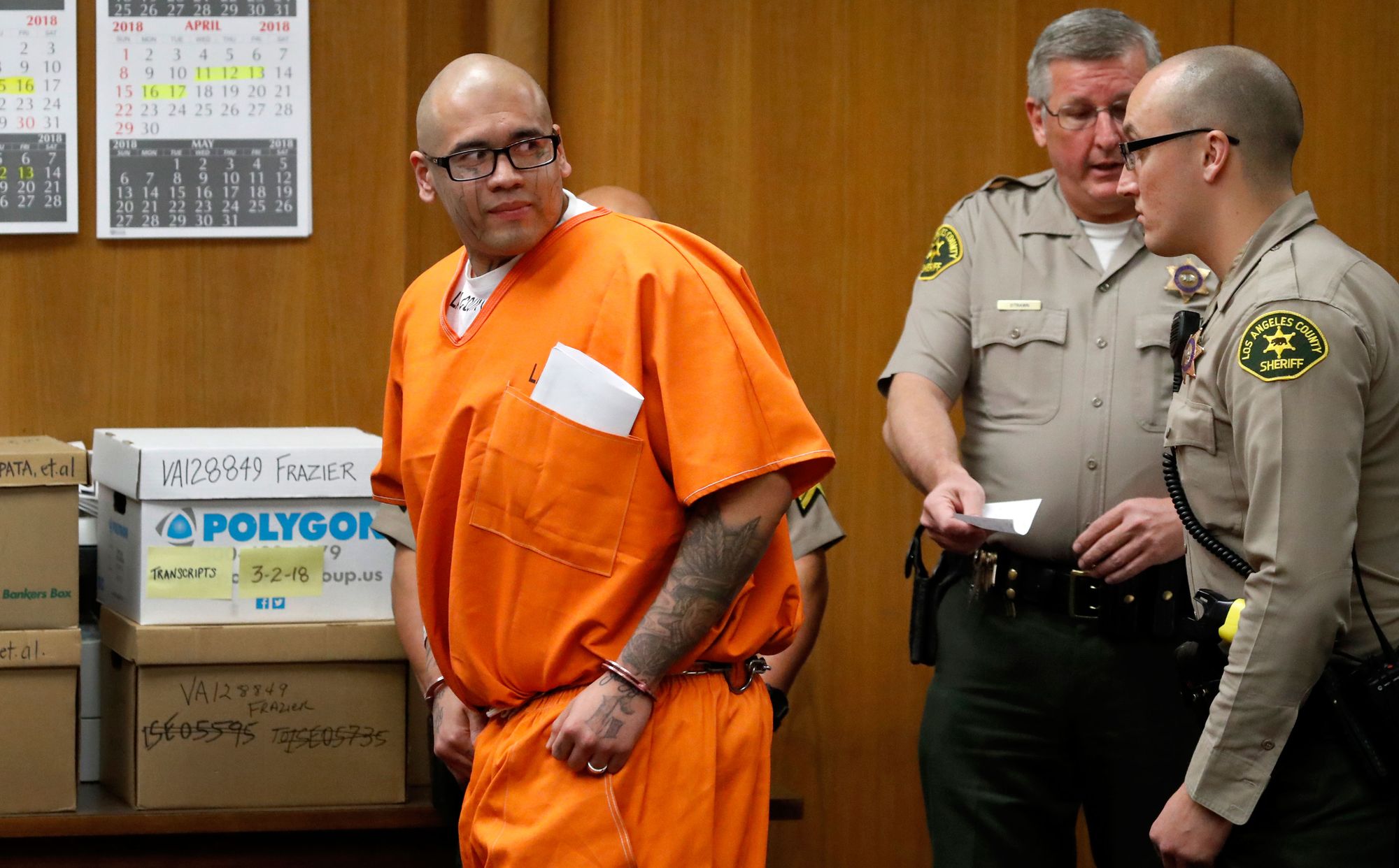 Michael Christopher Mejia is escorted out of court in February after a pre-trial hearing. He is charged with murder for the killings of Officer Keith Boyer of Whittier, Calif., and his own cousin, Roy Torres.