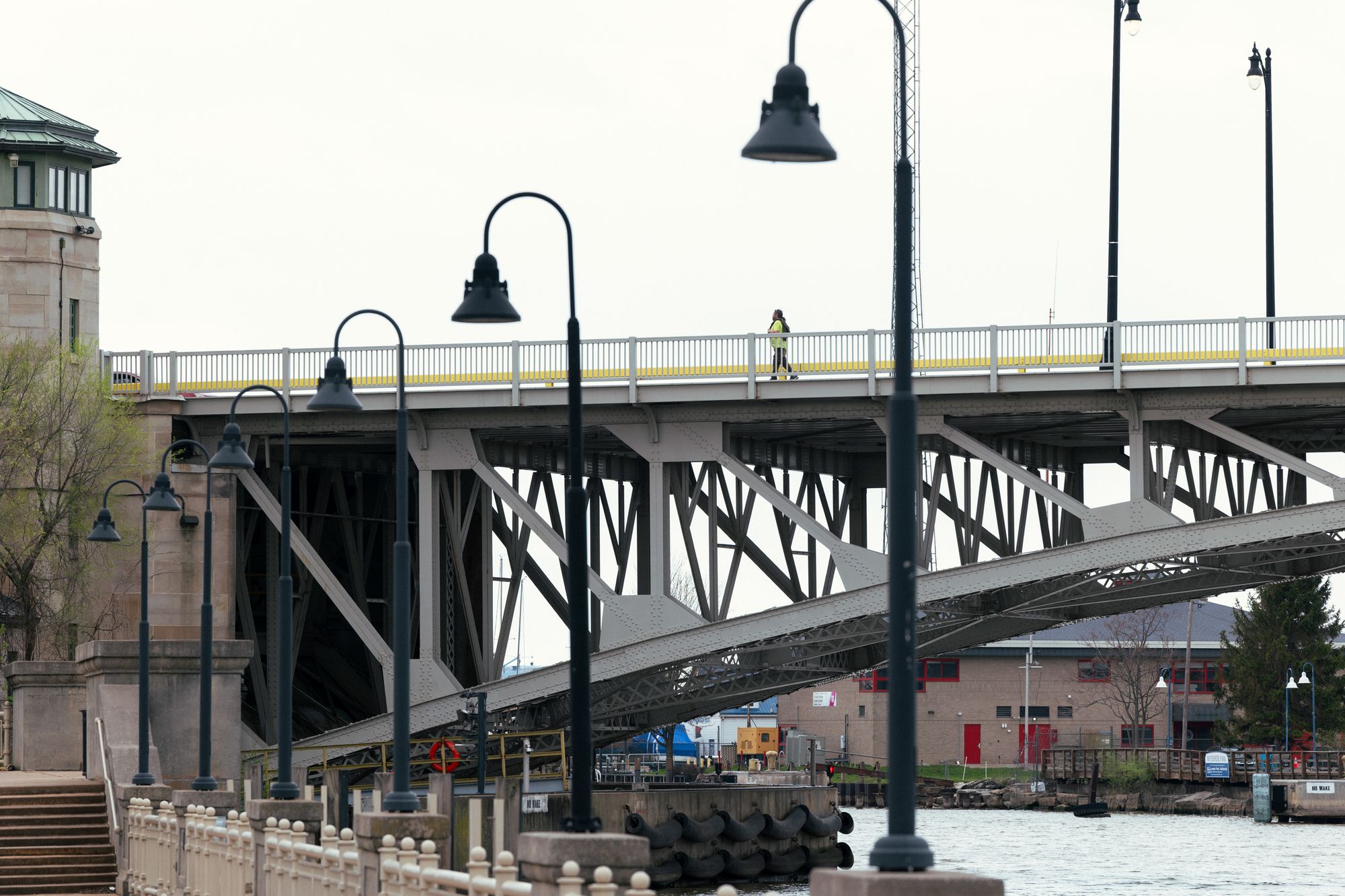 Right: A photo shows a steel mill, which is composed of pipes and metal structures. A brick building is on the left, and “R.R. Co.” is written on it. 