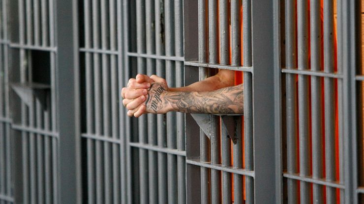 An inmate stands at his cell door at the maximum security facility at the Arizona State Prison in Florence, Ariz.