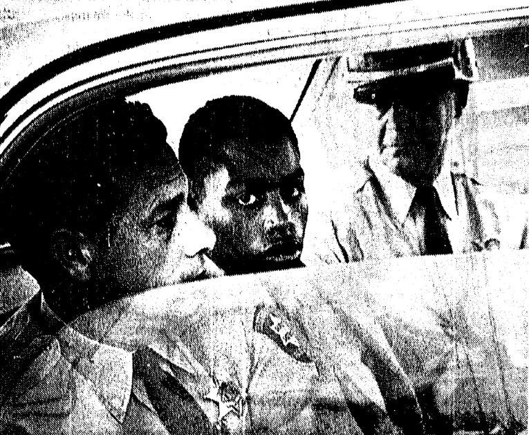 A photo from a Baton Rouge, La., newspaper shows Henry Montgomery, center, being escorted to court before his conviction for the 1963 murder of sheriff's deputy Charles Hurt. 