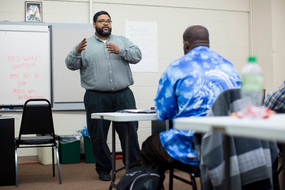 Tessie Amos III, a group facilitator, speaks to men during a Fathers' Support Center session on Sept. 30, 2015 in Wellston, Mo. 