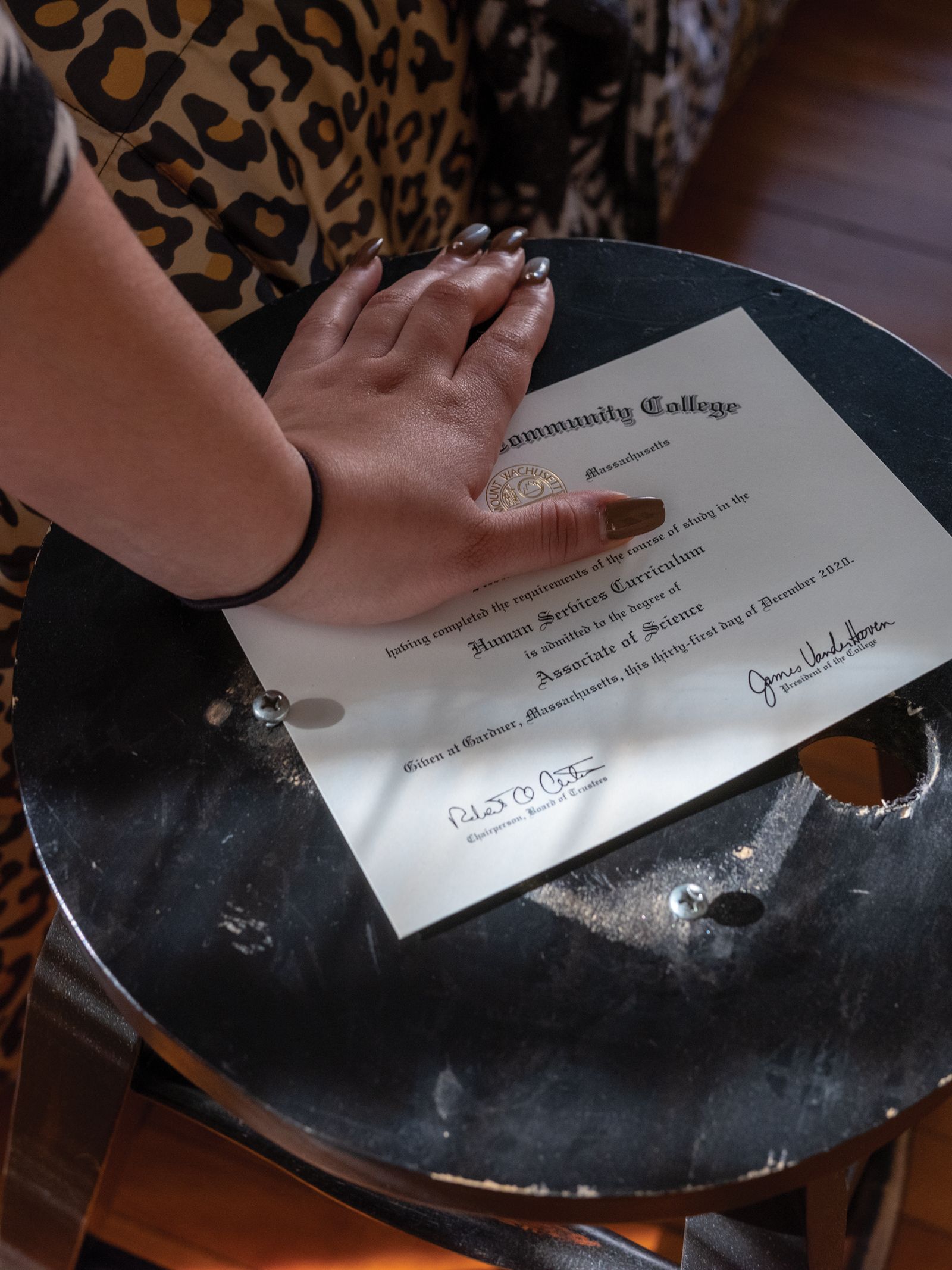 M. shows her diploma, which she received after graduating from a local community college. Since losing custody of her daughter in June of 2020, M. has graduated college, moved into a bigger apartment, continued therapy and attended parenting classes. 