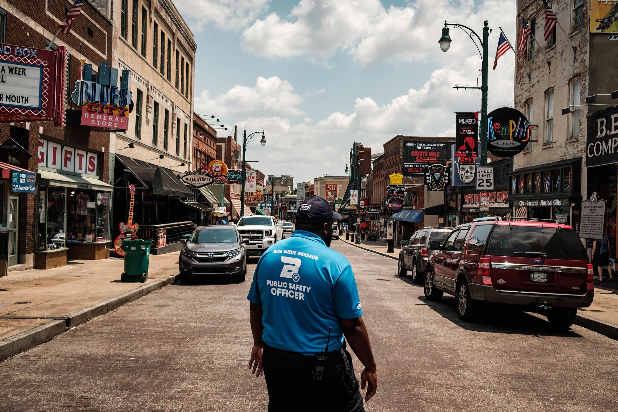 Capt. Eleslie Walker of the Blue Suede Brigade, a private security force, makes his way down Beale Street, a popular tourist destination in downtown Memphis. 