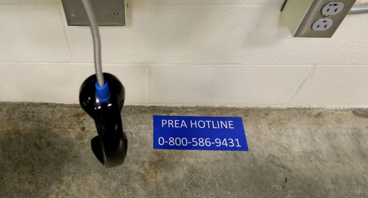 The PREA hotline number for offenders to call is pasted on the floor under a bank of phones at the Washington Corrections Center For Women in Gig Harbor, Wash.