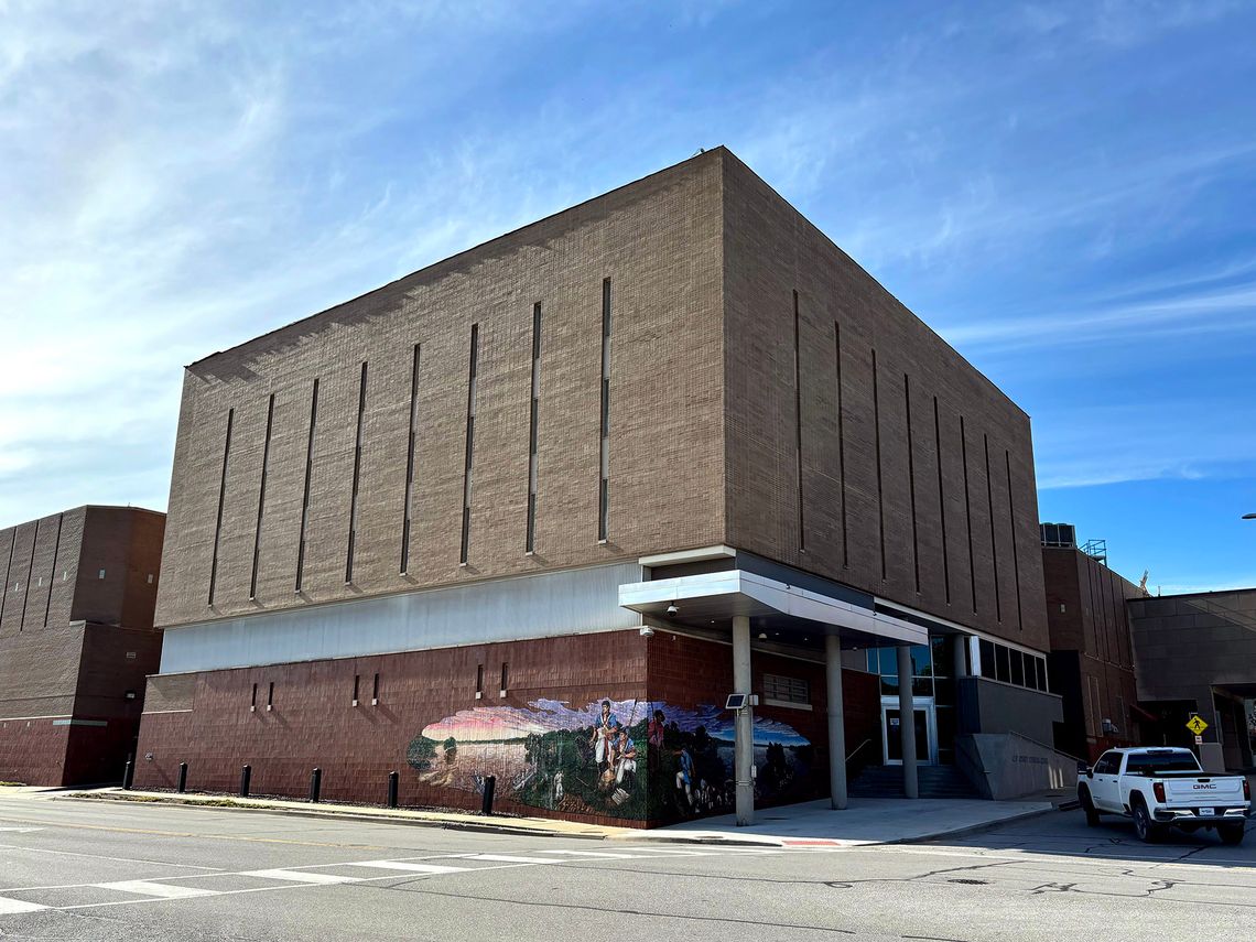 A photo shows a brick jail building with a mural of the Lewis and Clark expedition wrapping one corner.