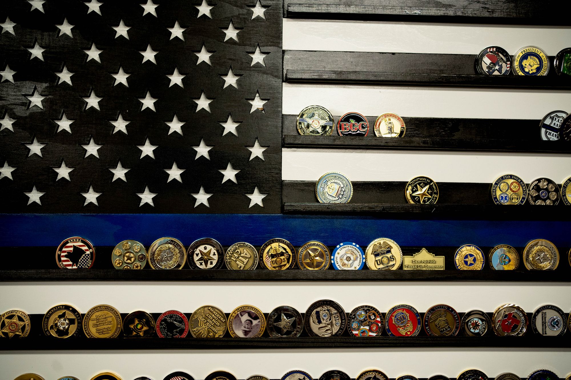 Medals belonging to Sheriff Larry Smith are stored on a "thin blue line" police flag at his office in Tyler, Texas.