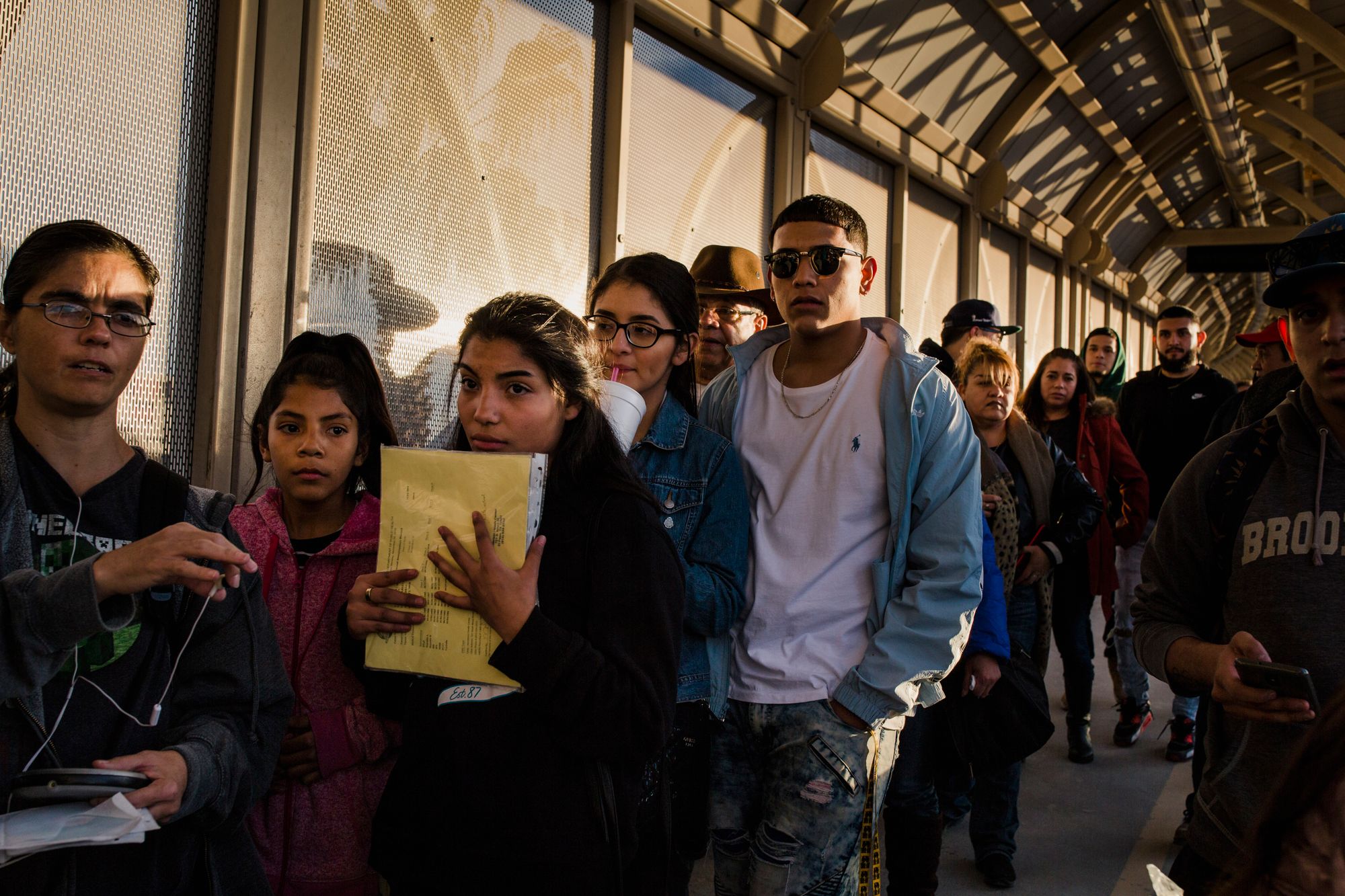 Lluvia Rodriguez and Juan Jesús Rojas line up to show their documentation to U.S. Customs and Border Protection.