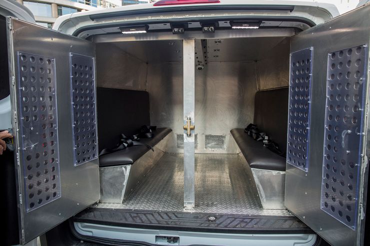 The rear holding compartment of a Prisoner Transportation Services van.