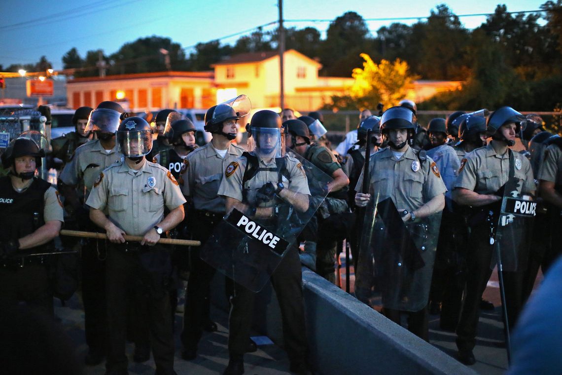 Police in Ferguson, Mo., stood watch on Aug. 13 as protesters gathered four days after Michael Brown's death. 