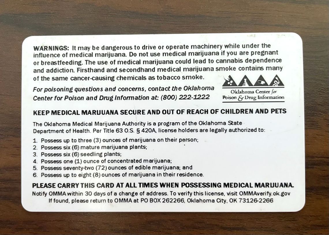 The back of a Oklahoma medical marijuana license card lists advisory warnings and the amounts of marijuana allowed in a license holder's possession. 