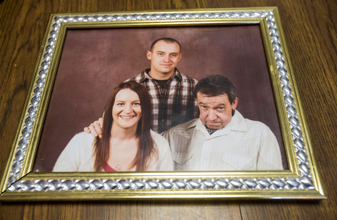 A family photo shows Nicholas Glisson, right, with his grown children, before he was sentenced to prison.