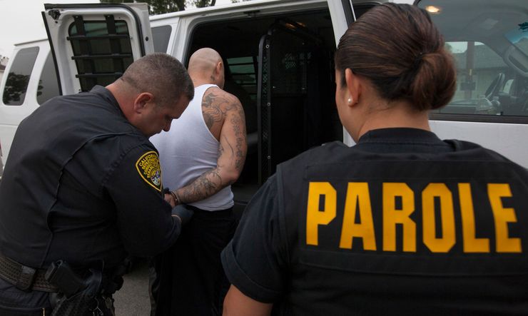 Parole agents in California arrest a man for violating his parole in 2012. California currently has no technical parole violators in its prisons, but many are incarcerated at the local level.