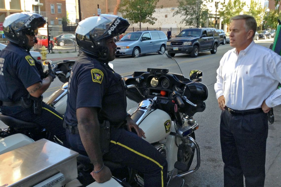 Former police chief Thomas Striecher talks with Cincinnati police officers in Over-the-Rhine. 