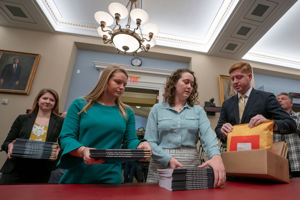 Office of Management and Budget staff members deliver President Donald Trump’s 2020 budget to the House Budget Committee on Capitol Hill. 