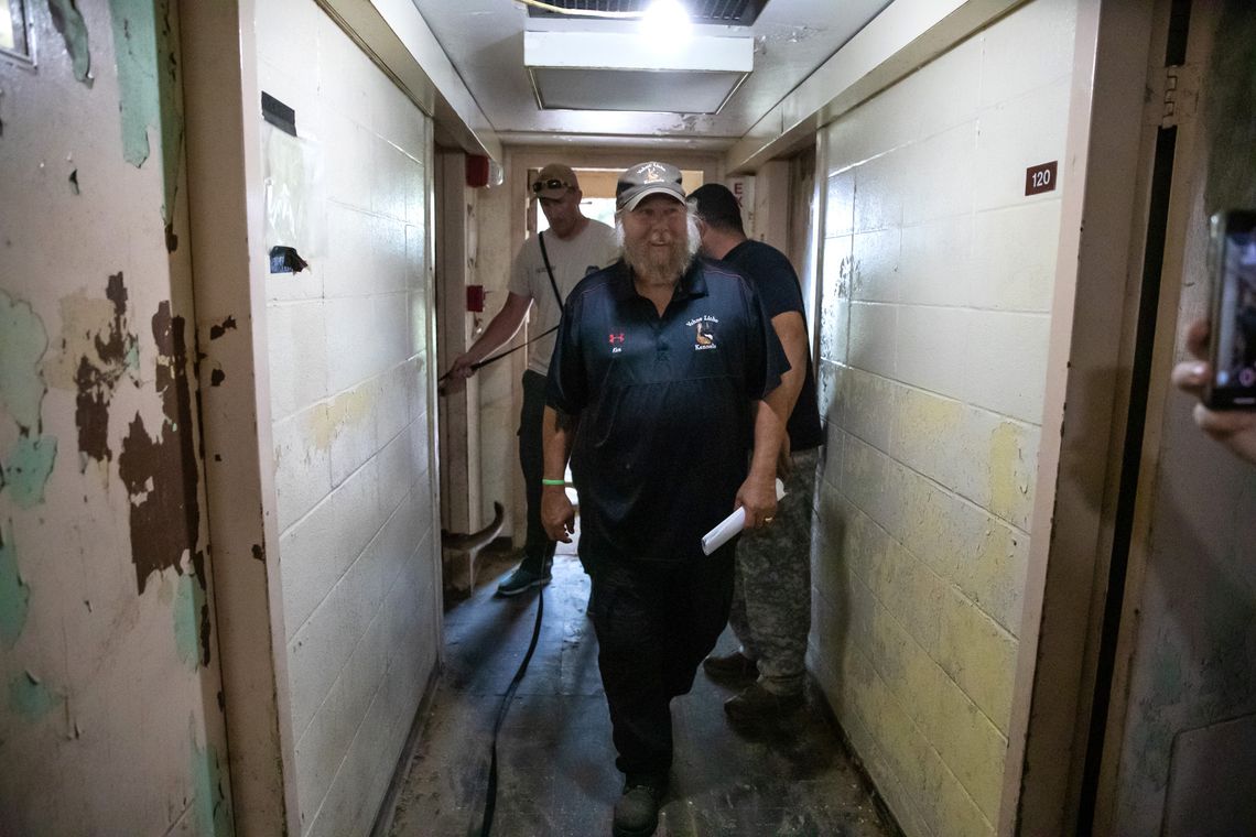 Kenneth Licklider, owner of Vohne Liche Kennels, walks through a hallway in one of the many training buildings at his facility, in Indiana, in September. Licklider, who founded the company in 1993 after retiring from the military, has been training canines for more than 40 years. 