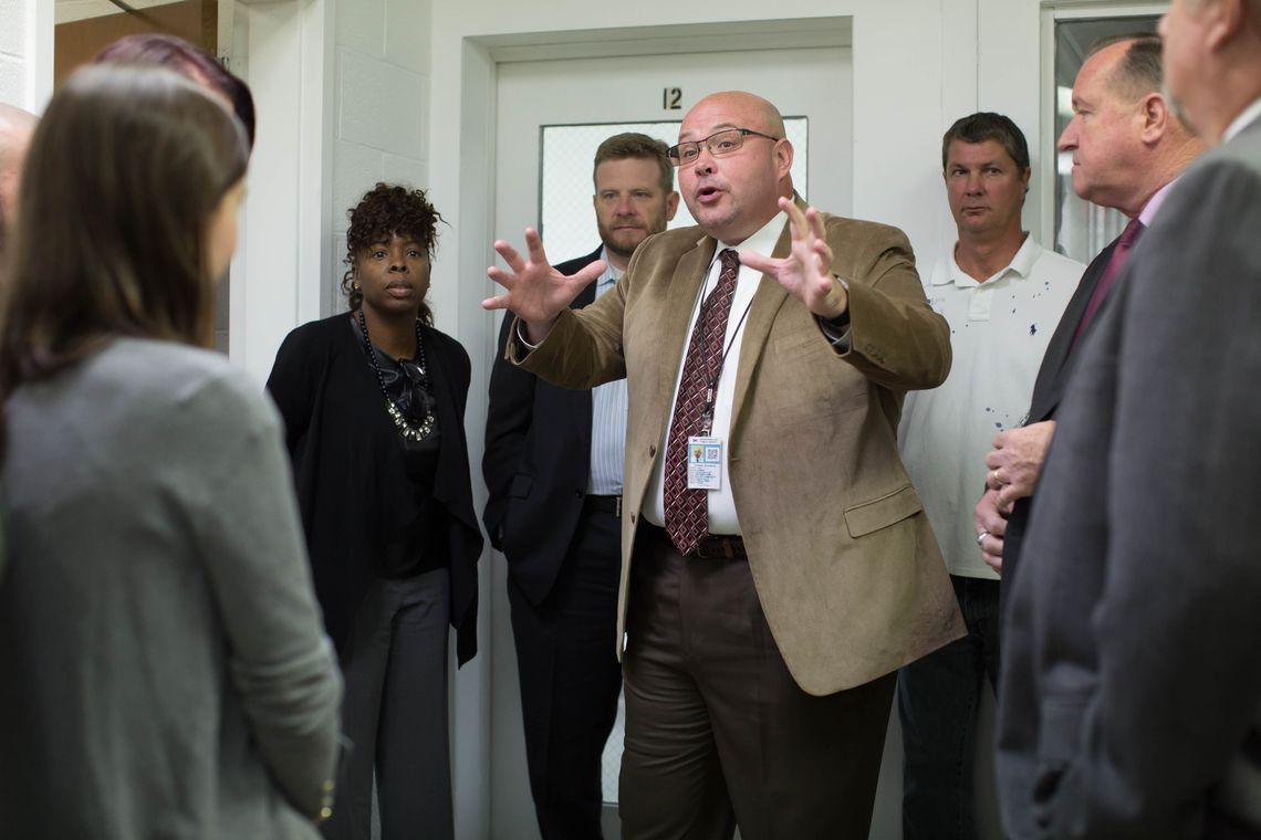 Edward Thomas, the warden at Central Prison, talks to a group during a tour.