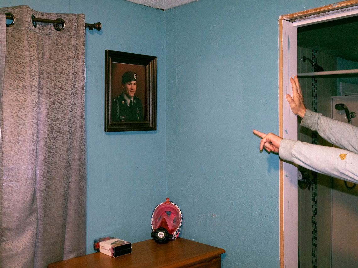 Chuck’s military photo on the wall of his bedroom, a reminder of his life before incarceration.