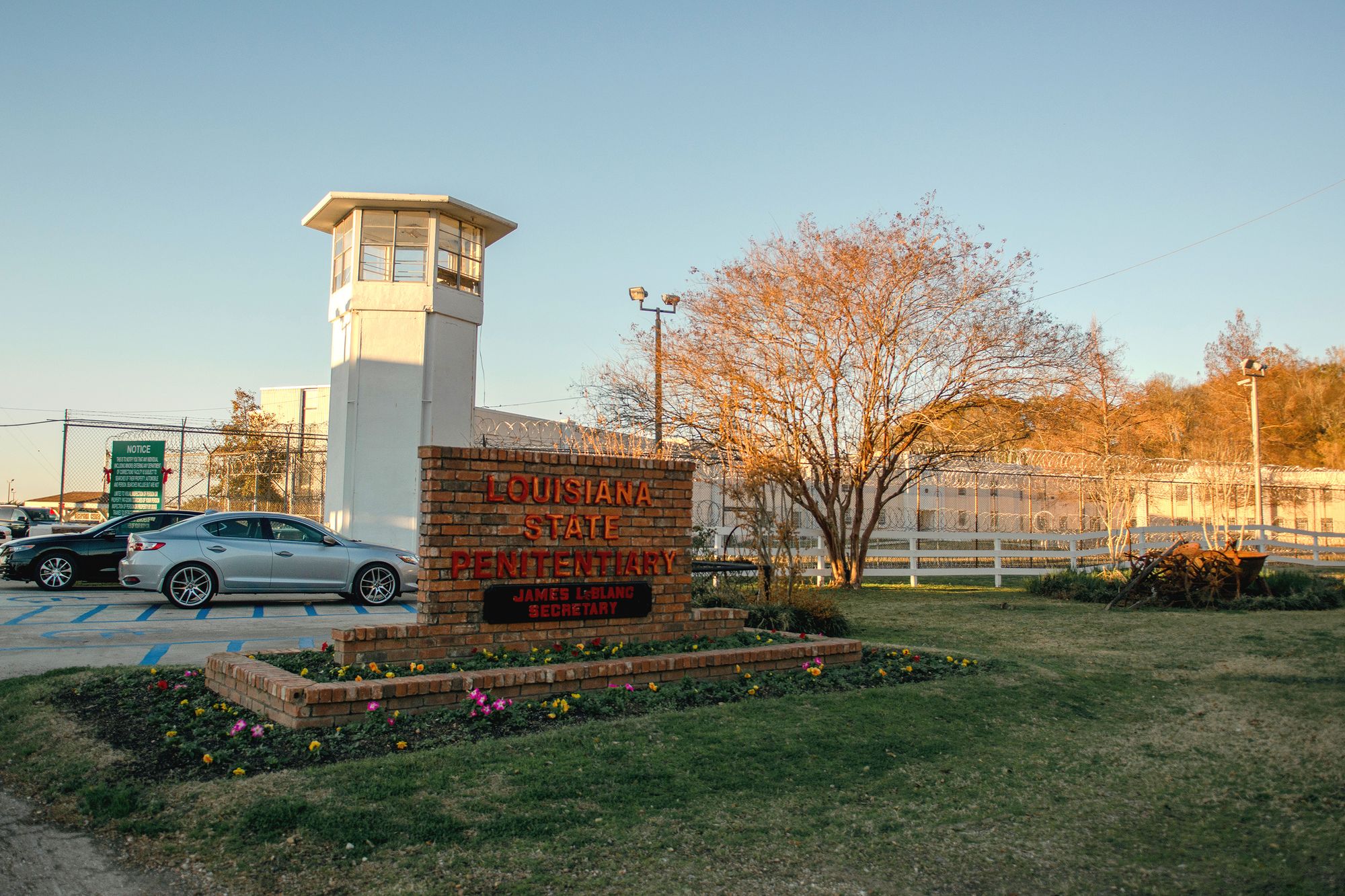 A brick sign that reads "Louisiana State Penitentiary" and "Secretary James LeBlanc" located in front of the prison's entrance. 