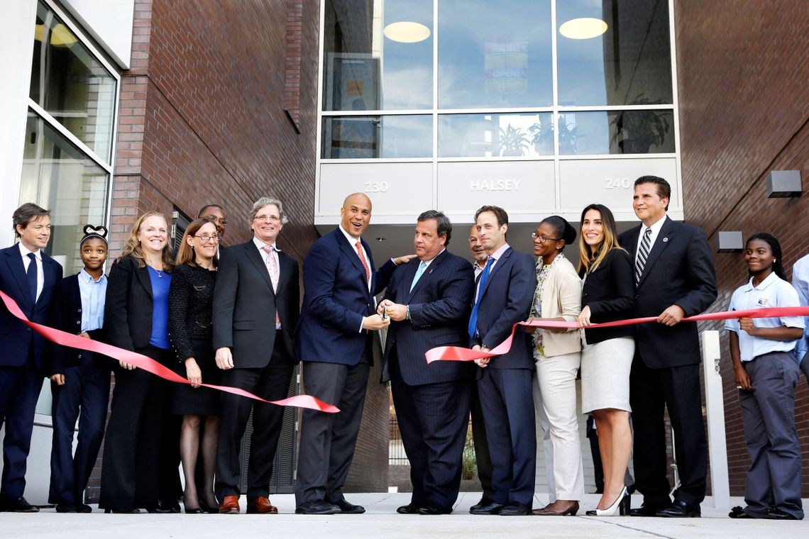 Cory Booker, center left, with New Jersey Gov. Chris Christie, center right, at a ribbon cutting for a section of Newark’s Teachers Village project in Sept. 2013. 