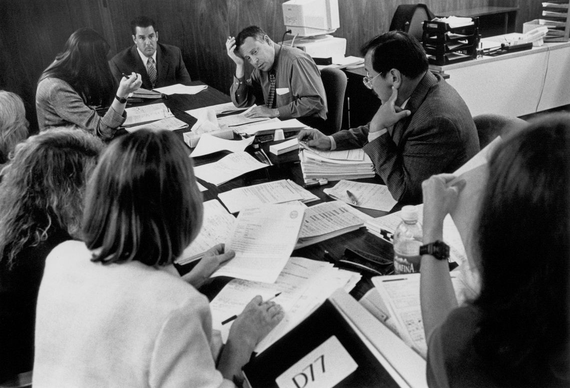 Judge Eugene Michael Heyman plans the calendar for the juvenile justice division with district attorneys, public defenders, a social worker, and a parole officer. (San Jose, 1999)