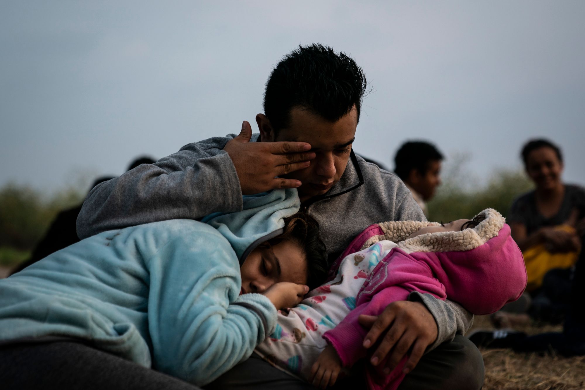 Families wait to be searched and loaded into transport vans taking them to the U.S. Border Patrol McAllen Station after they were caught in a group of immigrants that illegally crossed into the United States from Mexico in May of 2019, in Los Ebanos, Texas.